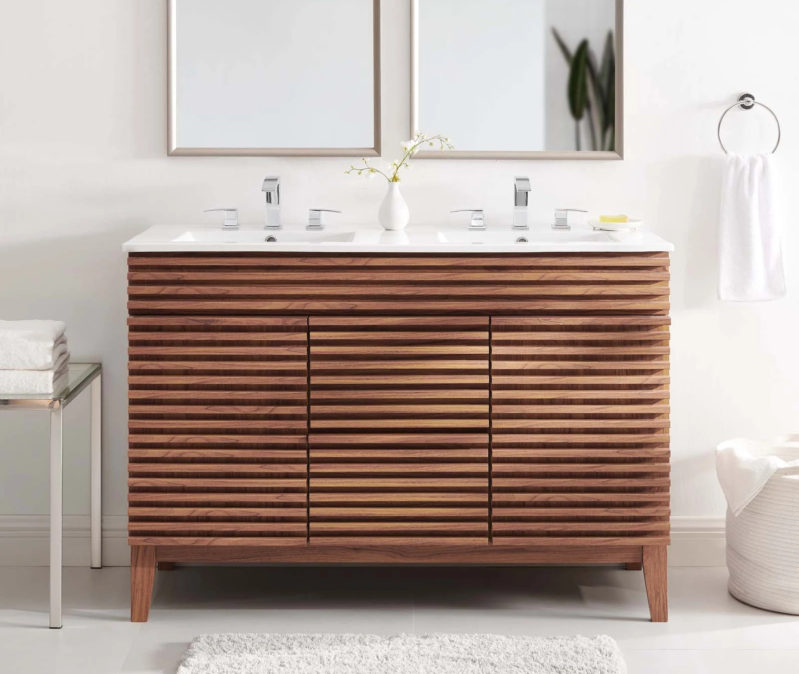 A bathroom vanity with a marble top and a mirror.